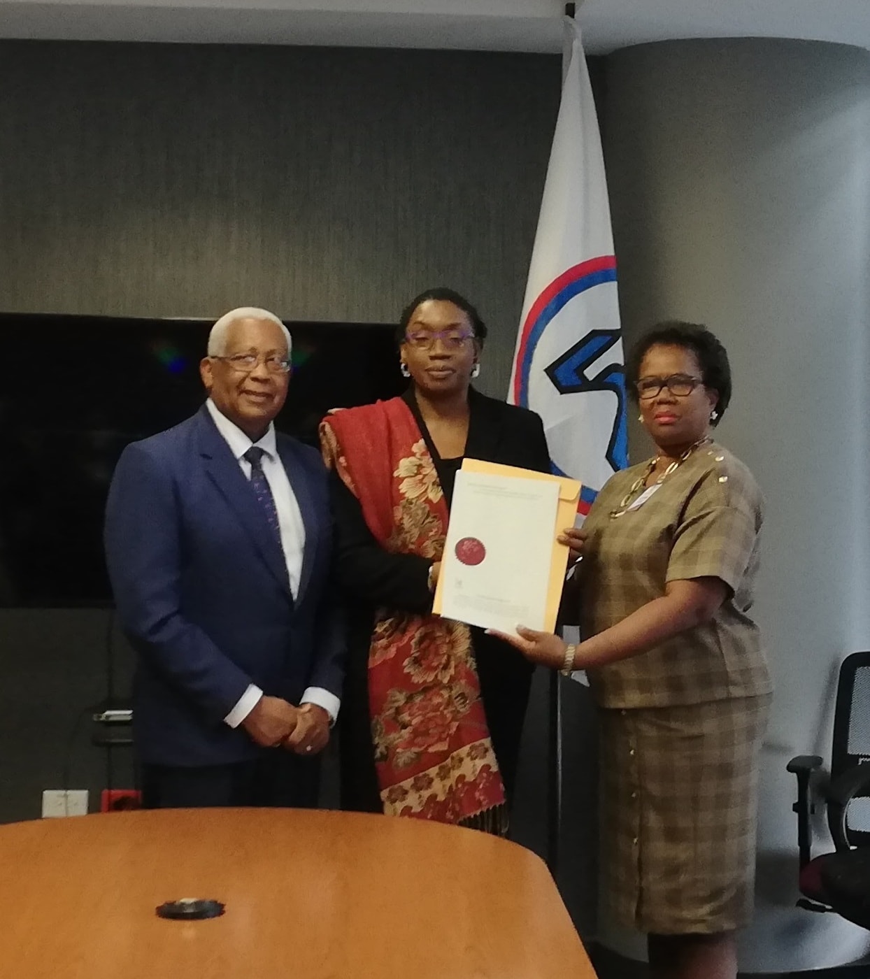 NIHERST President Marleen Lord-Lewis (far right) is presented with her Instrument of Appointment by the Honourable Anthony Garcia, Minister of Education and Lenor Baptiste-Simmons, Permanent Secretary in the Ministry of Education, at a ceremony held at the Education Towers on Monday 5th August, 2019. 