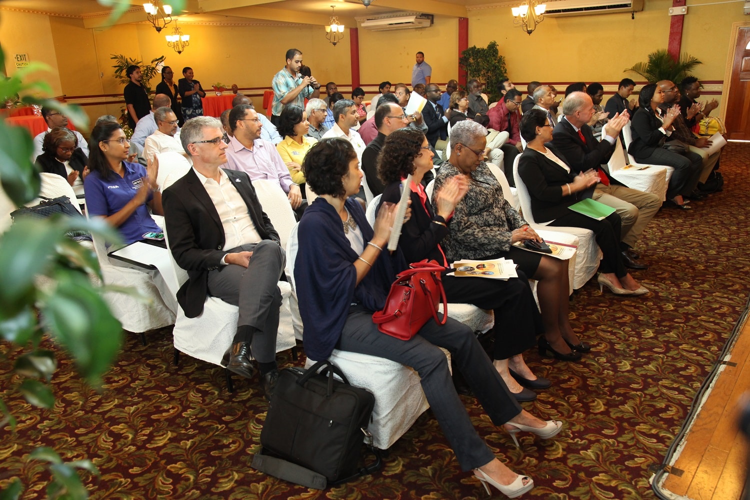 The audience listens attentively to the research findings on the Energy Services Sector.